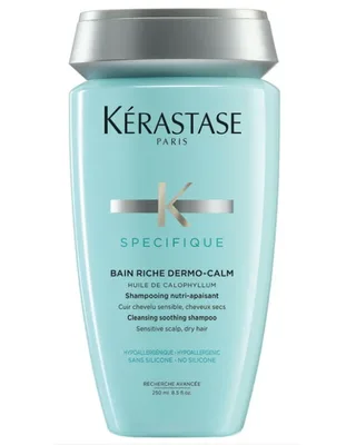 A pale blue shampoo bottle photographed flat against white