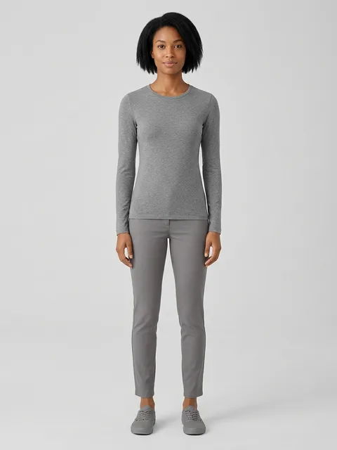 Full-length studio portrait of a saved AI model in grey loungewear on a plain grey ground