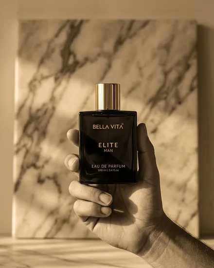 The bottle held against warm veined marble in low side light