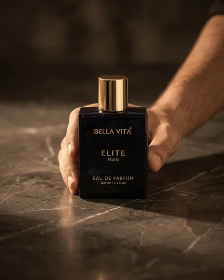 The bottle standing on dark marble with a hand reaching in behind it