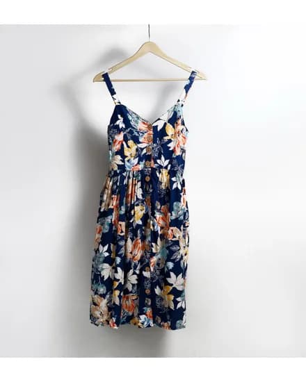 The garment as uploaded: a floral summer dress on a wooden hanger against a white wall